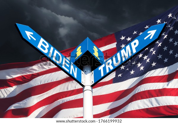 US presidential race. The names of\
Presidents Donald Trump and Joe Biden on the roadside sign on the\
background of the American flag and a stormy\
sky