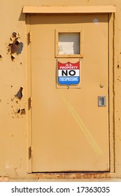 U.S. Property No Trespassing Sign On Disused Naval Base Door, Alameda, California