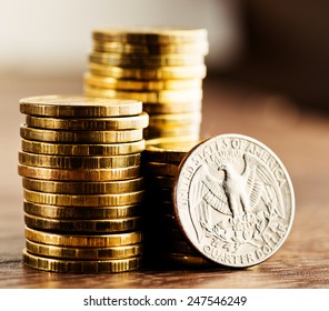 Us Quarter Dollar Coin And Gold Money On The Desk