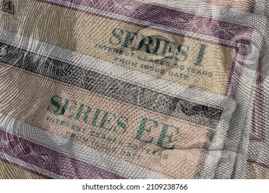 US Savings Bonds with 100 dollar bill overlay. Savings bonds are debt securities issued by the U.S. Department of the Treasury. They are issued in Series EE or Series I. - Shutterstock ID 2109238766