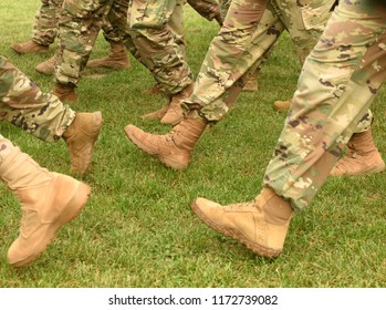 US Soldiers Legs In Green Camouflage Military Uniform. US Troops