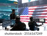 US soldiers operating in a high tech cybersecurity command post, managing state secrets and classified information. Protecting the national servers against digital threats and cyber warfare.