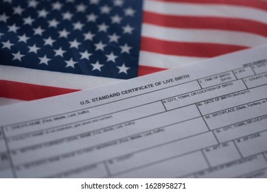 U.S. Standard Certificate Of Live Birth Application Form Next To Flag Of USA. Birthright Citizenship Concept. 