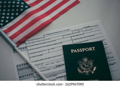 U.S. Standard Certificate Of Live Birth Application Form Next To American Flag And Passport Of USA. USA Birthright Citizenship Concept. 