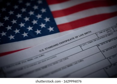 U.S. Standard Certificate Of Live Birth Application Form Next To Flag Of USA. Birthright Citizenship Concept. 