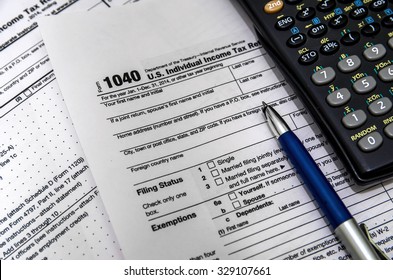 US Tax Form 1040 With Pen And Calculator.