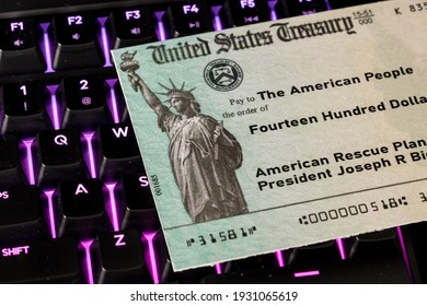 US Treasury Concept Check To Illustrate Coronavirus Stimulus Payment On Keyboard Used For Working From Home