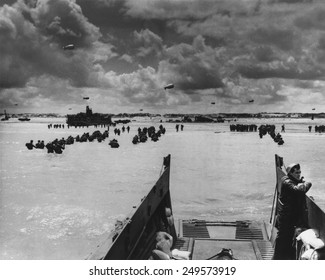U.S. Troops land at Normandy on D-Day. With the beach taken and barrage balloons deterring German aircraft, soldiers and supplies flooded into France in June 1944, during World War 2.