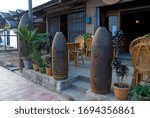 US unexploded bombs collected after bombings of the town during 1965-1973 located outside of a residential building in Phonsavan, Laos.