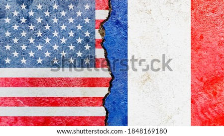 US (United States) vs France national flags on broken wall with cracks background, abstract US France politics conflicts concept