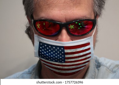 US Versus China : An American Portrait During Corona Virus Restrictions, Wearing An US Flag Mask, But Facing China Flag.