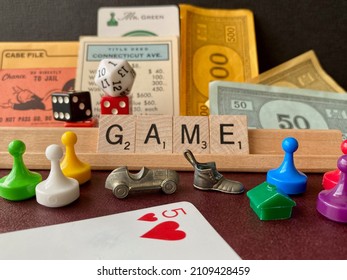 USA - 2022: GAME Pieces From Monopoly, Scrabble, Clue, Playing Cards (five Of Hearts), And Dice. Go Directly To Jail Card, Mr. Green, Connecticut Avenue Title Deed, Monopoly House, Letter Tiles, Pawns