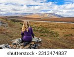 Usa, alaska, noatak national preserve. visitor looking out over the noatak river. (mr)