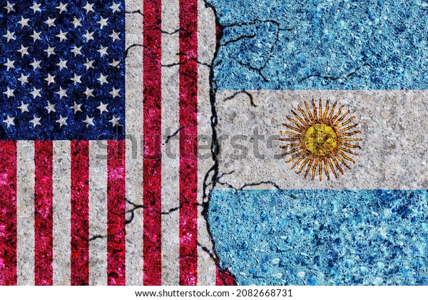 USA and Argentina painted\
flags on a wall with grunge texture. USA and Argentina relations.\
United States of America and Argentina flags together. USA vs\
Argentina