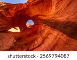 USA, Arizona, Monument Valley Navajo Tribal Park. Big Hogan Arch and hole in rock.