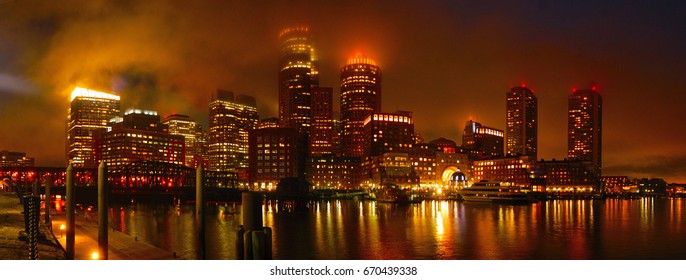 USA, Boston, skyline, skyscrapers and waterfront. July 8th, 2016. Panorama view of Boston downtown at foggy night from the waterfront.