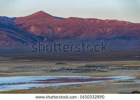 USA, California, Mono County, Mammoth Lakes, A view across the LongValley Caldera at sunset to the volcanic crater rim known as the Glass Mountain Range. Stock photo © 