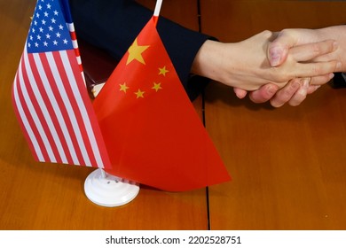 USA And China - Agreement, US Of America And Chinese Flags And Shake Hands. Relationship Between USA And China. Trade Deal Concept