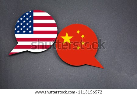 USA and China flags with two speech bubbles on dark gray background 