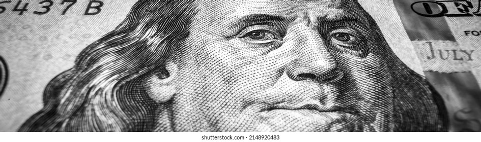 USA dollar bill close up, Benjamin Franklin portrait on 100 US dollar note. Panoramic macro shot of paper money, president face in one hundred dollar banknote for website header. USD currency concept
