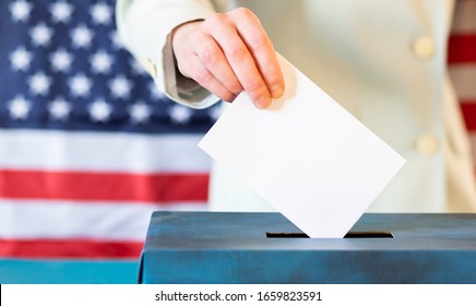 Usa Elections  The Hand Of Woman Putting Her Vote In The Ballot Box