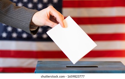 Usa Elections  The Hand Of Woman Putting Her Vote In The Ballot Box