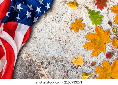 USA flag buried in yellow dry leaves. Autumn texture - Powered by Shutterstock