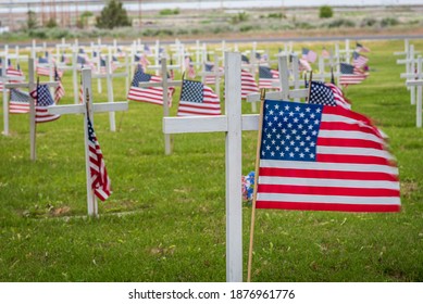 USA flag in cemetery with cross