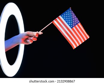 USA Flag. Independence Day. Patriotic Pride. 4th July. Female Hand Holding American National Symbol In Glowing LED Light Ring Isolated On Black Background.