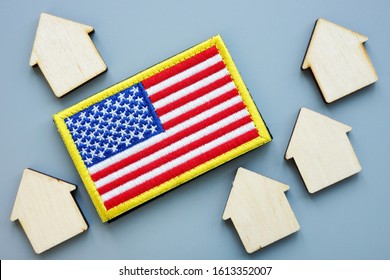 USA Flag And Models Of House. VA Direct Home Loan Concept.