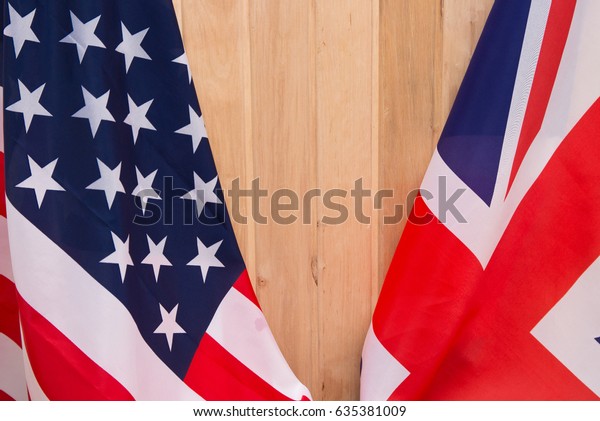 USA flag and
UK Flag on wooden background
light.