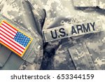 USA flag U.S. ARMY patch on military uniform - studio shot. Filtered image: cross processed vintage effect.