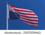 USA flag waving upside down on a flagpole