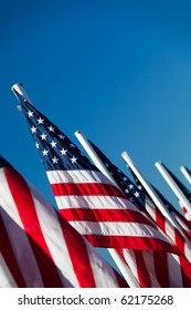 USA flags in a row - American flags lined up, shot angled under clear blue sky