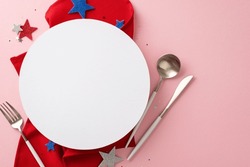 USA Freedom Day Party Table Arrangement. Top View Of Symbolic Items: Silverware, Napkin, Patriotic Colored Stars. Pastel Pink Backdrop With An Empty Circle For Text Or Promo Placement