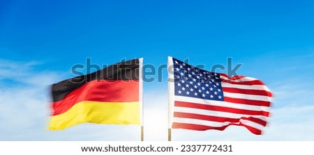 USA and German flags against blue sky background Stock photo © 