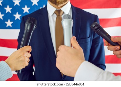 USA government representative in suit being asked questions by American newspaper reporters and TV journalists with microphones shares information and gives official comment. Press conference concept - Powered by Shutterstock