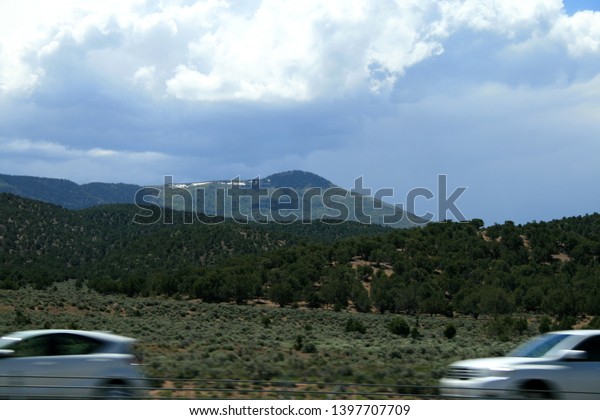 USA.\
Green mountains Utah. Gray Mountains in Utah. View from the highway\
from car. Spring, fine weather. Grass on the\
rocks