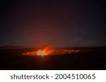 USA, Hawaii, Big Island of Hawaii. Hawaii Volcanoes National Park, Lava and steam eruption at Halemaumau Crater in evening.