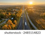 USA highway transportation infrastructure at sunset. American freeway road with fast driving cars