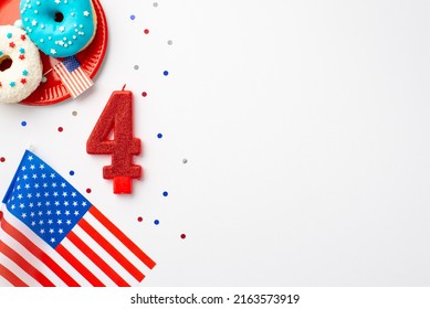 USA Independence Day concept. Top view photo of US national flags number 4 candle confetti and plate with glazed donuts on isolated white background with copyspace