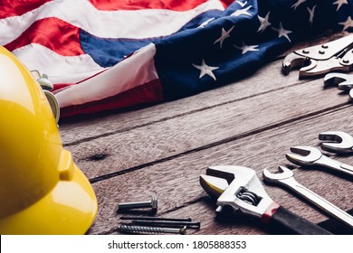 USA Labor day concept, Top view flat lay of different kinds wrenches with American flag on wood table. First Monday in September, creation of labor movement and dedicated to social of American worker - Shutterstock ID 1805888353