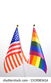 USA and LGBT. Two table flags on a white background. The concept of a meeting of American people with representatives of non-traditional sexual orientation. Copy space.