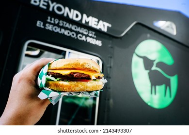 USA, LOS ANGELES, November 2019: Vegan Burger Beyond Meat In Hand On Truck Background. Beyond Meat - A Producer Of Plant-based Meat Substitutes. Vegan Meat Logo