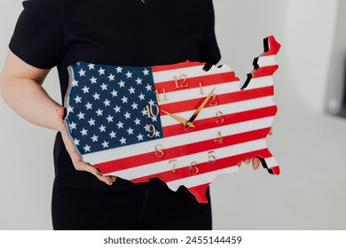 USA map. A clock in the form of a map of America. In hands - Powered by Shutterstock