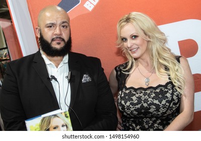 USA, Miami, FL - SEPTEMBER 7, 2019; Stormy Daniels and her bodyguard at EXXXOTICA 2019 held at the Miami Airport Convention Center.
