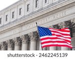 USA national flag waving in the wind in front of United States Court House in New York