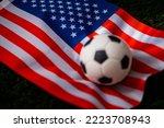 USA national football team. National Flag on green grass and soccer ball. Football wallpaper for Championship and Tournament in 2022. World international match.