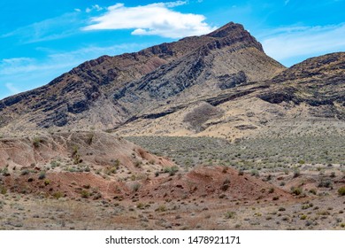 USA, Nevada, Clark County, Gold Butte National Monument. Dry Annual Grasses Color Lime Ridge Yellow. Red Tinted Gypsum Hills In Foreground.