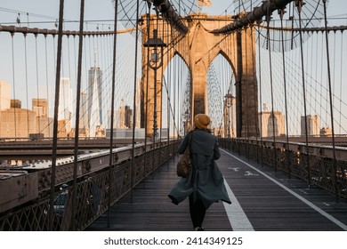 Usa- new york- new york city- female tourist on brooklyn bridge in the morning light - Powered by Shutterstock